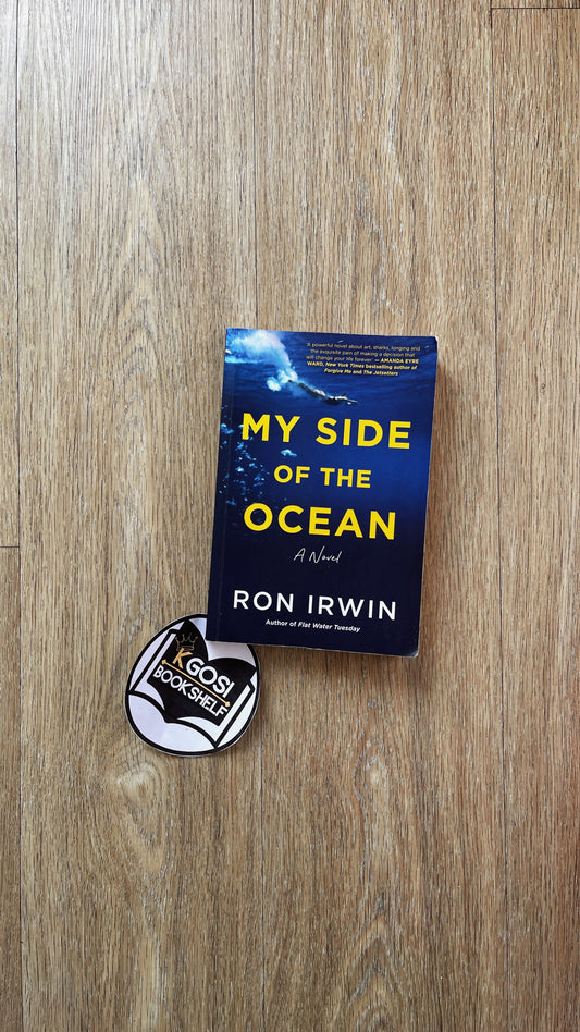 Book titled 'My Side of the Ocean' by Ron Irwin on a wooden surface with a sticker underneath.